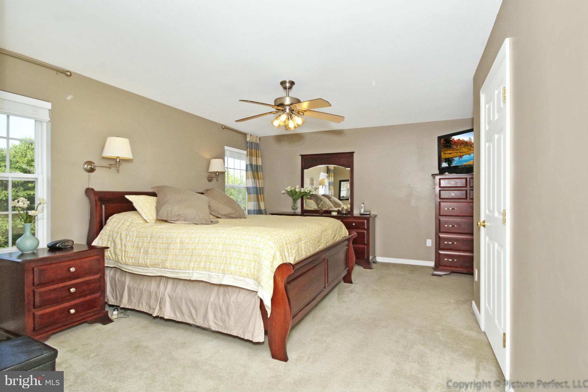 9014 Bealls Farm Road Frederick, MD 21704 - Photo 14 of 30 a bedroom with a bed and a chandelier