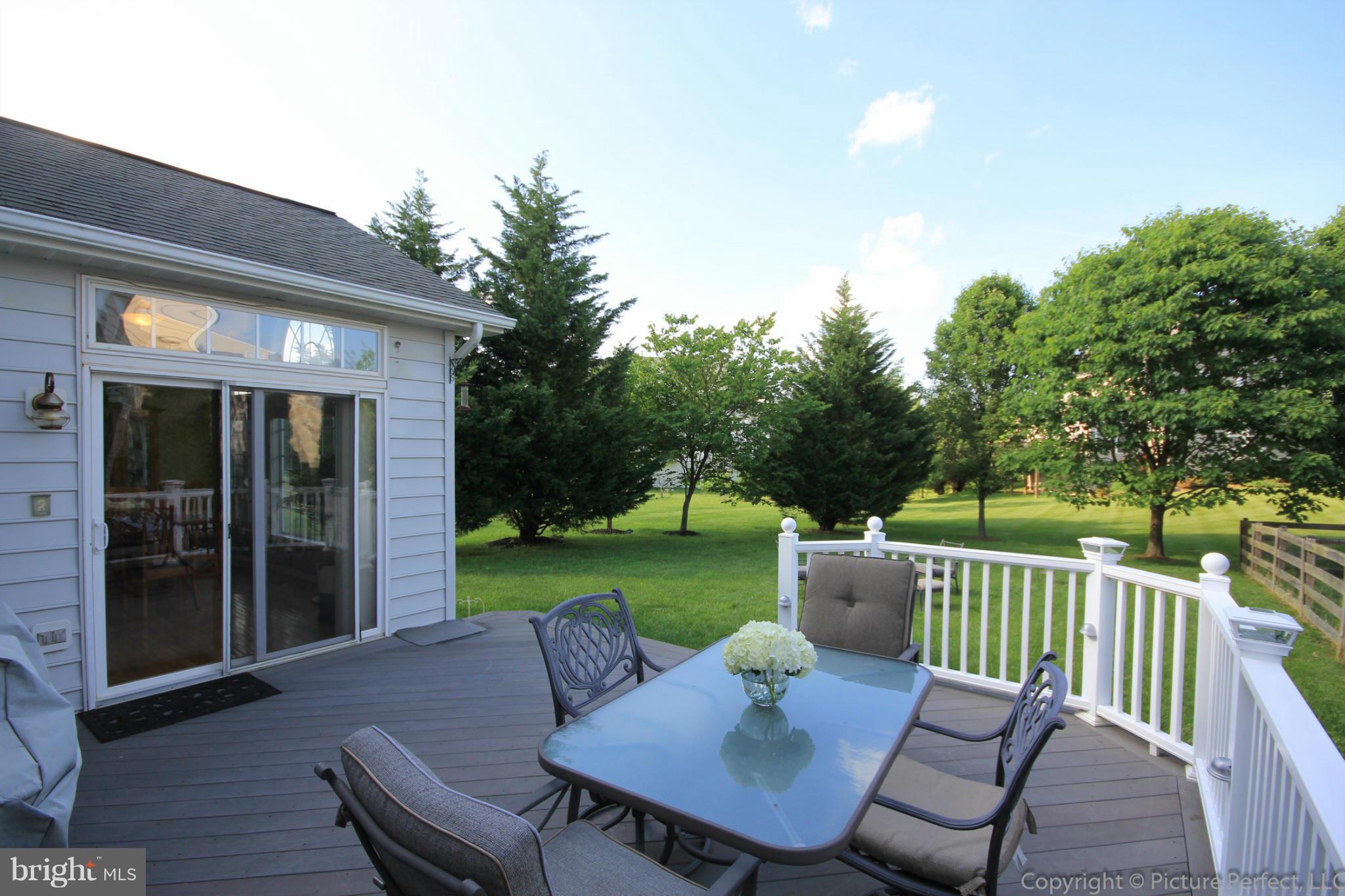 9014 Bealls Farm Road Frederick, MD 21704 - Photo 21 of 30 a view of a patio with a table chairs and a backyard