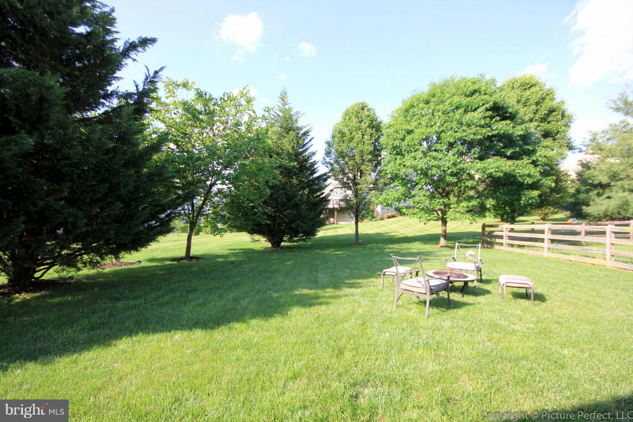 9014 Bealls Farm Road Frederick, MD 21704 - Photo 23 of 30 a backyard of a house with table and chairs