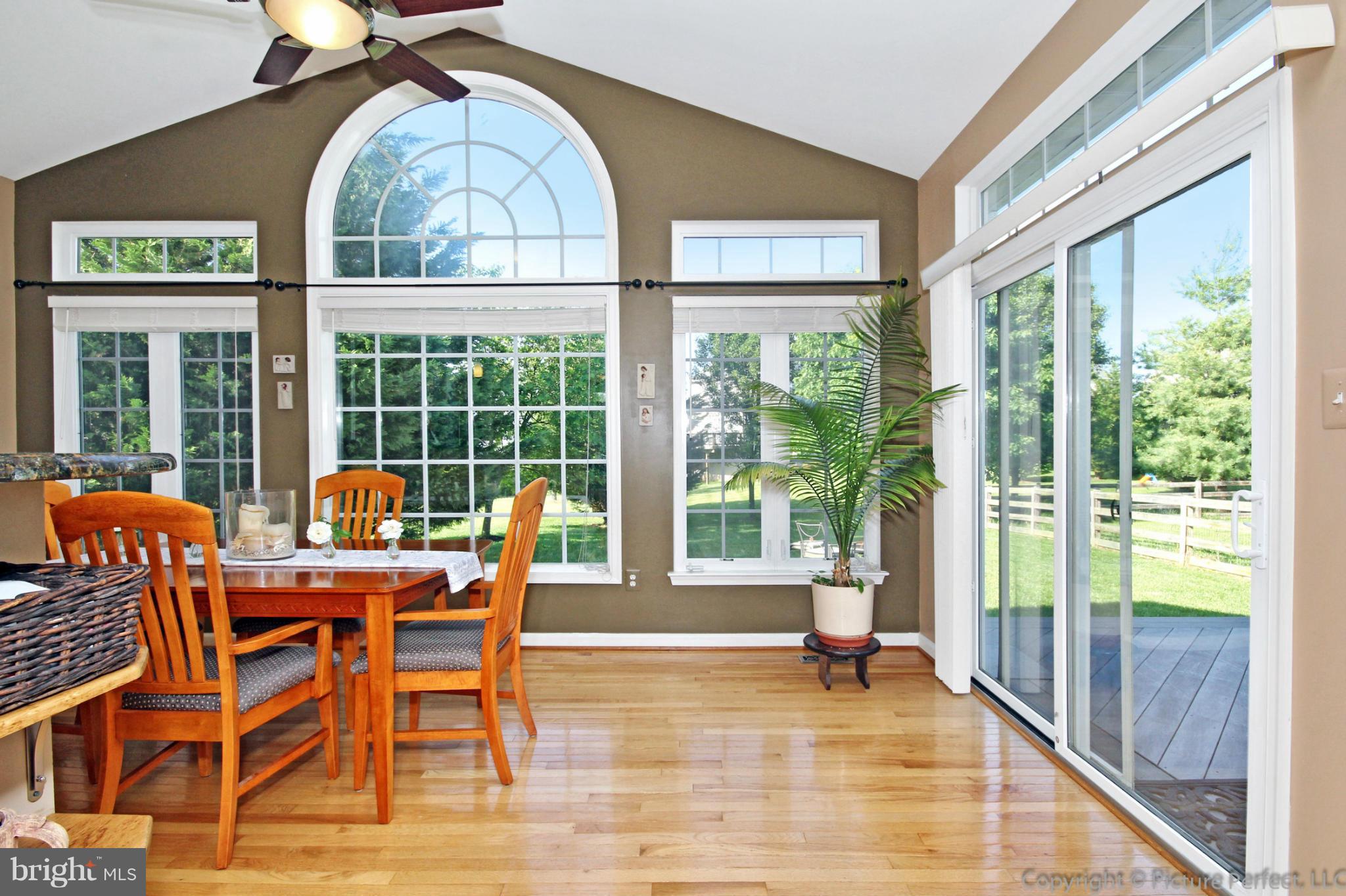 9014 Bealls Farm Road Frederick, MD 21704 - Photo 4 of 30 a dining room with wooden floor and glass door
