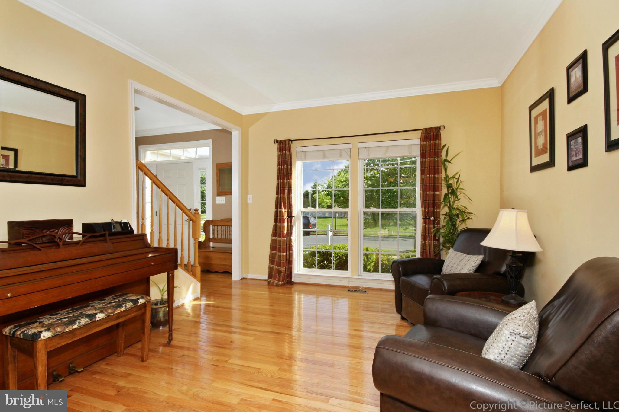 9014 Bealls Farm Road Frederick, MD 21704 - Photo 6 of 30 a living room with furniture and a fireplace next to a window