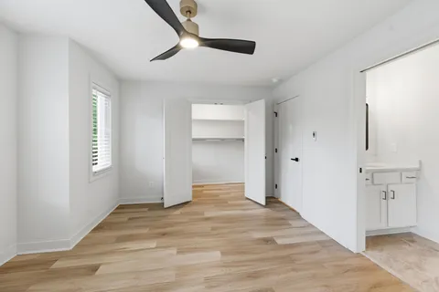 an empty room with closet and windows