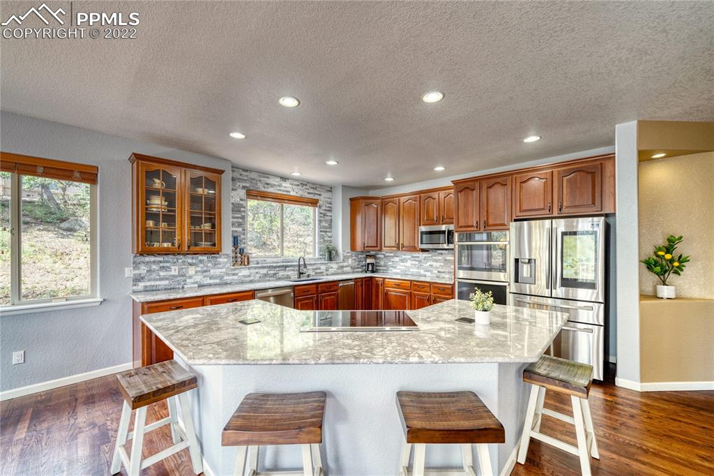 6205 Colfax Terrace Colorado Springs, CO 80906 - Photo 12 of 43 a kitchen with kitchen island a large window in it