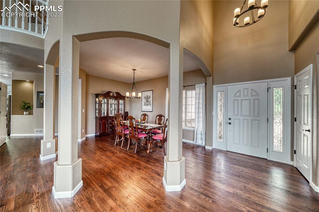 6205 Colfax Terrace Colorado Springs, CO 80906 - Photo 14 of 43 a view of a livingroom with furniture wooden floor and a chandelier