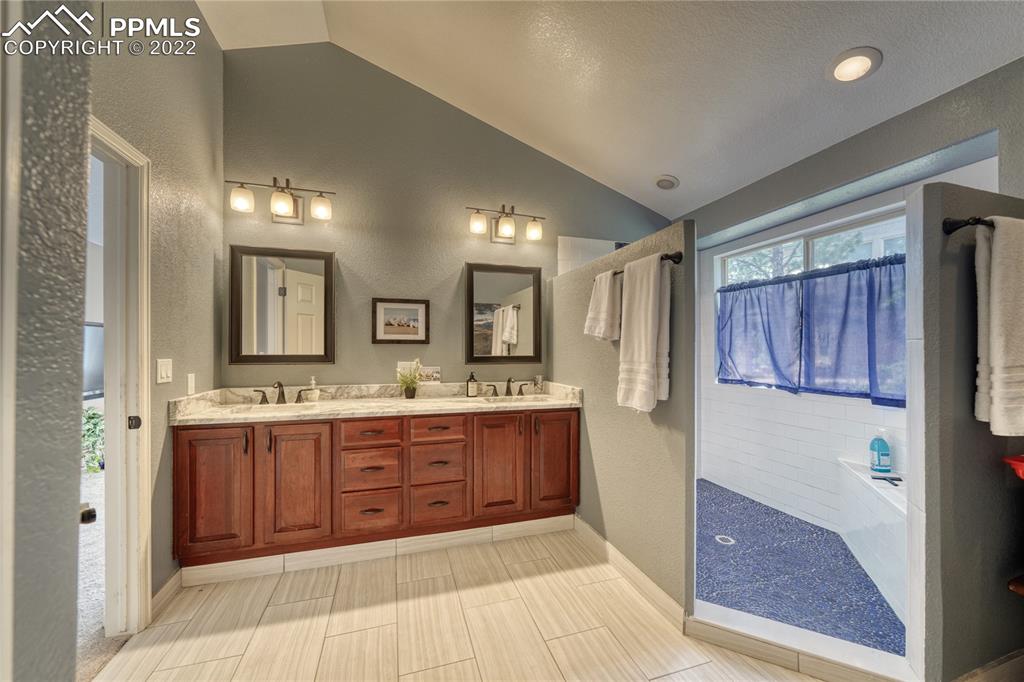 6205 Colfax Terrace Colorado Springs, CO 80906 - Photo 17 of 43 a large bathroom with a double vanity sink and a mirror