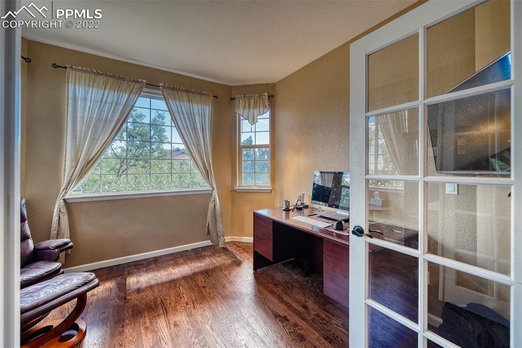 6205 Colfax Terrace Colorado Springs, CO 80906 - Photo 19 of 43 a view of workspace with wooden floor and windows