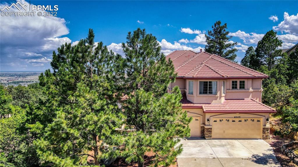 6205 Colfax Terrace Colorado Springs, CO 80906 - Photo 2 of 43 a front view of a house with a yard