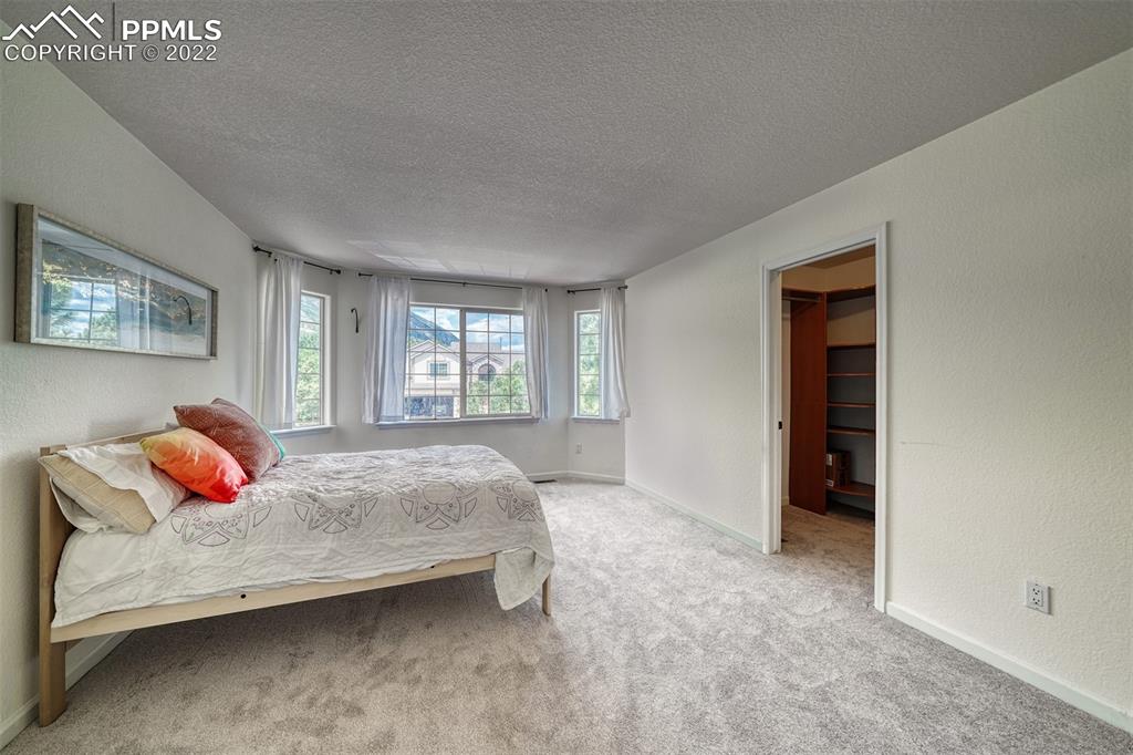 6205 Colfax Terrace Colorado Springs, CO 80906 - Photo 29 of 43 a bedroom with a bed and window