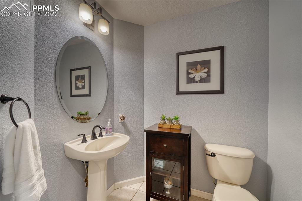 6205 Colfax Terrace Colorado Springs, CO 80906 - Photo 33 of 43 a bathroom with a toilet sink and mirror