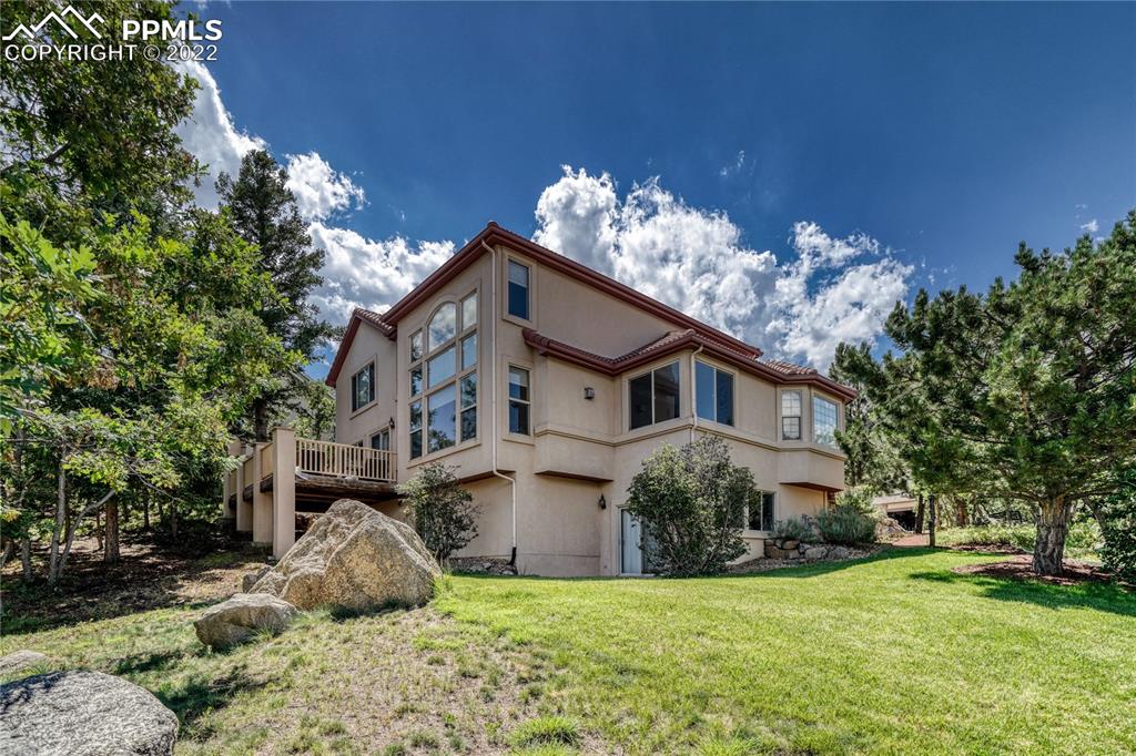 6205 Colfax Terrace Colorado Springs, CO 80906 - Photo 39 of 43 a view of a house with a big yard and large trees