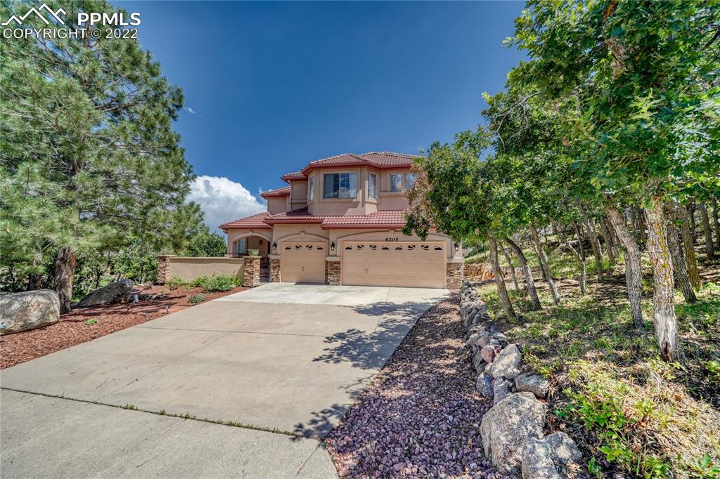 6205 Colfax Terrace Colorado Springs, CO 80906 - Photo 4 of 43 a front view of a house with a yard