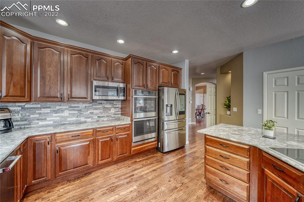 6205 Colfax Terrace Colorado Springs, CO 80906 - Photo 10 of 43 a kitchen with stainless steel appliances granite countertop a refrigerator and a sink