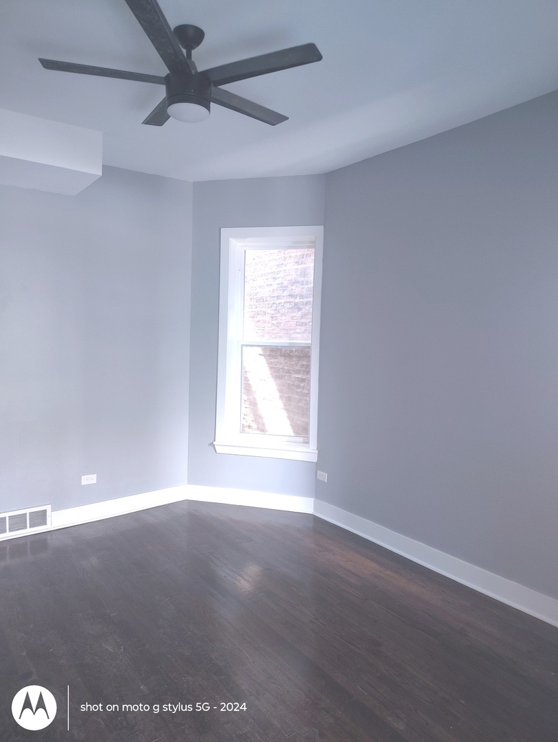 1661 South Homan Avenue, Unit 2 Chicago, IL 60623 - Photo 6 of 11 a view of an empty room with a window