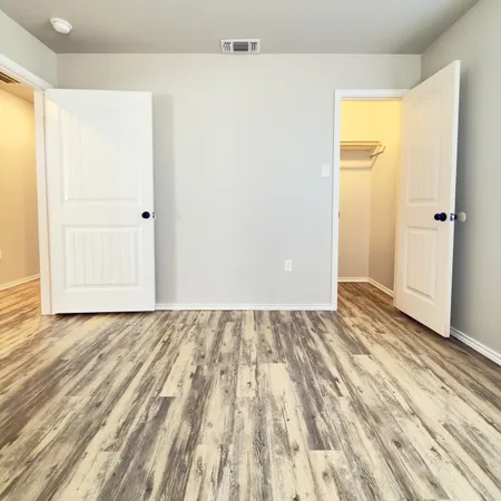 a view of a room with wooden floor and closet