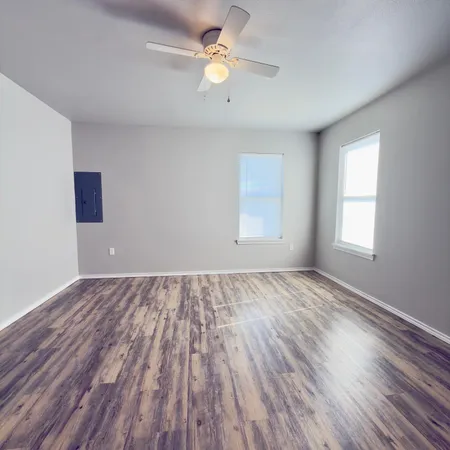 wooden floor in an empty room with a window