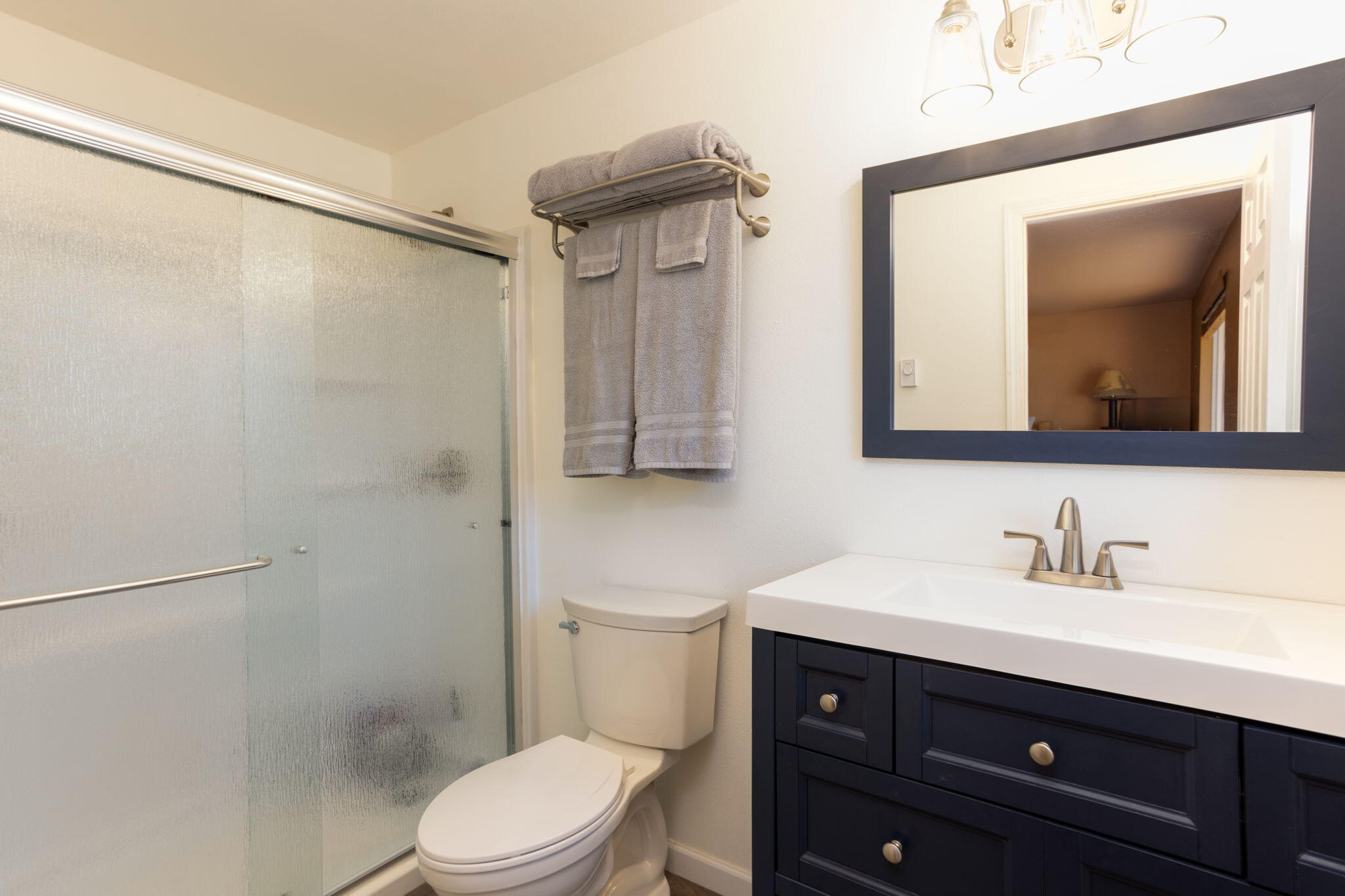 19450 Calico Road Bend, OR 97702 - Photo 18 of 41 a bathroom with a toilet a sink and mirror