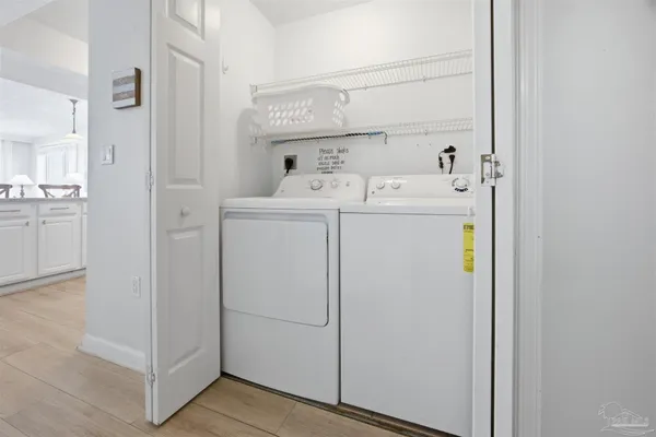 a view of a hallway with washer and dryer