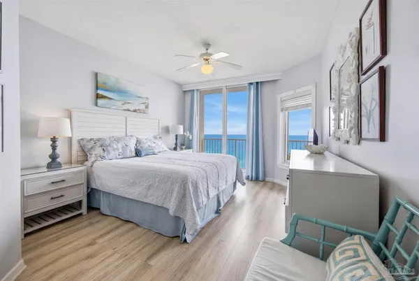 a spacious bedroom with a bed and a cabinets