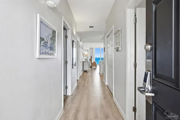 a living room with furniture a flat screen tv and a large window