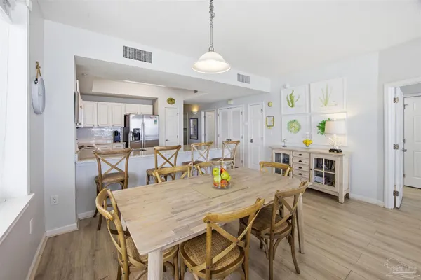 a view of a a dining room with furniture window and wooden floor