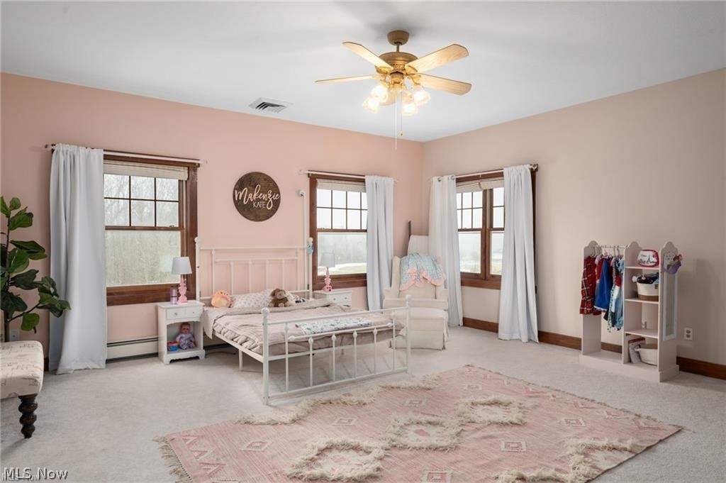 9419 Robinson Road Chardon, OH 44024 - Photo 31 of 49 Spacious room with a ceiling fan light fixture, light-toned carpeting, and a trio of large windows featuring dark wood trim