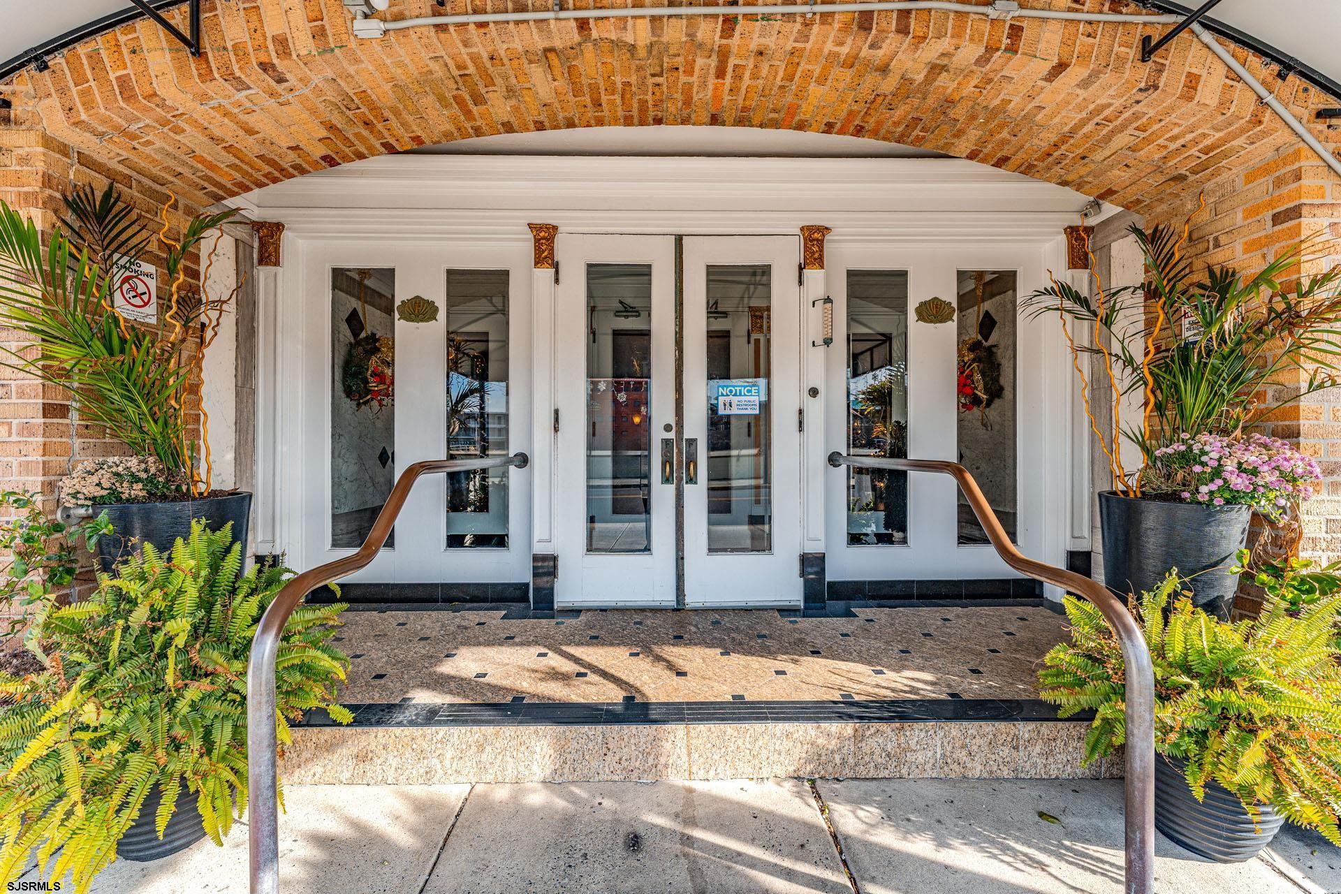 719 East 11th Street, Unit 810 Ocean City, NJ 08226 - Photo 14 of 25 a view of a brick house with potted plants