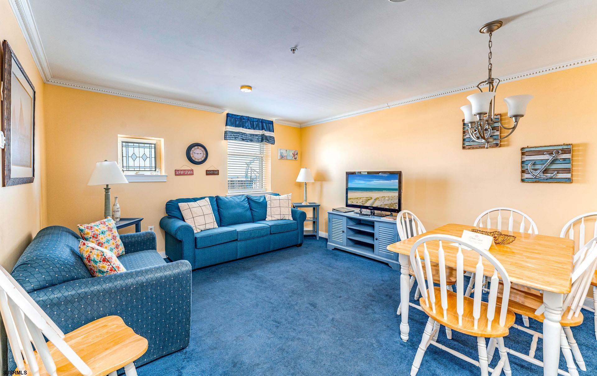 719 East 11th Street, Unit 810 Ocean City, NJ 08226 - Photo 4 of 25 a living room with furniture and a flat screen tv