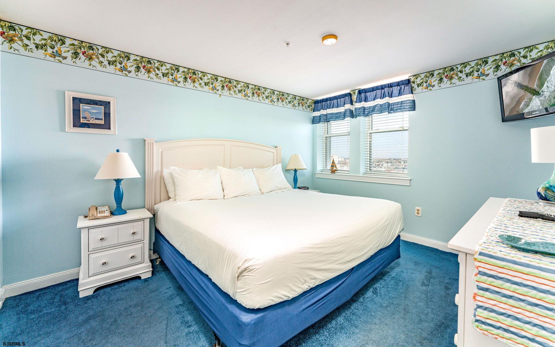 719 East 11th Street, Unit 810 Ocean City, NJ 08226 - Photo 10 of 25 a bedroom with a bed and a window