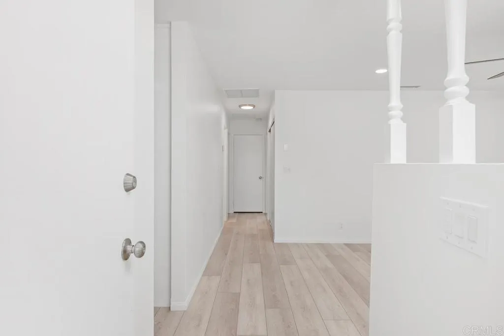889 Bracero Road Encinitas, CA 92024 - Photo 4 of 59 a view of a hallway with wooden floor