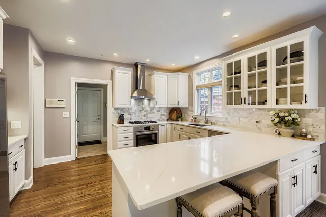 a kitchen with a sink a stove and cabinets