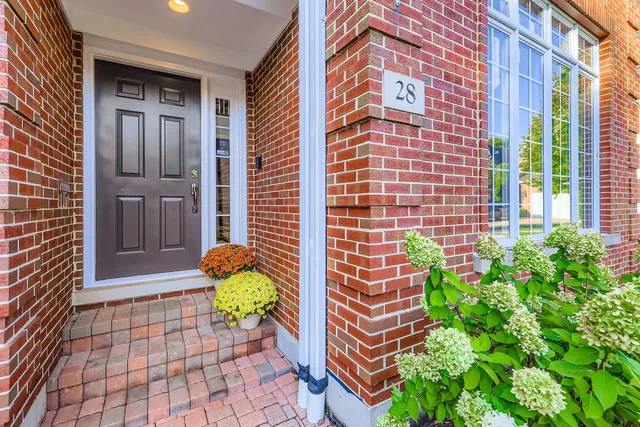a view of a brick house with potted plants