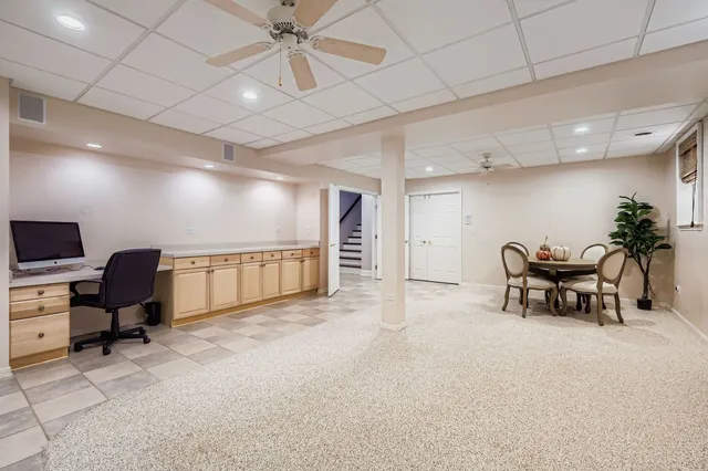 a view of a workspace with furniture and a projector