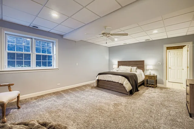 a bedroom with a bed and ceiling fan