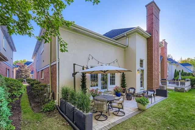 a view of a house with backyard sitting area and garden