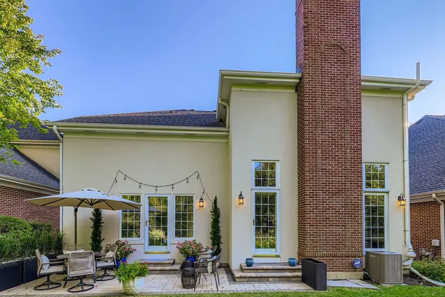 a view of a patio with table and chairs under an umbrella