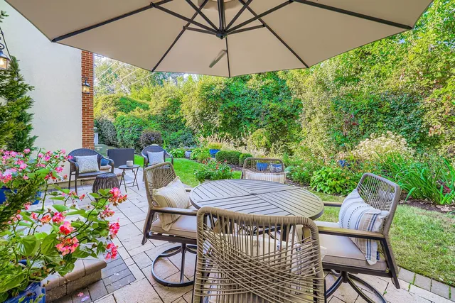 a view of a patio with furniture and a garden