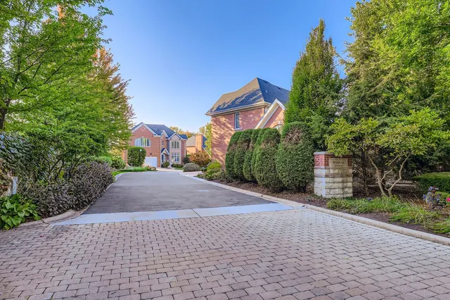 a front view of a house with a yard and a garage