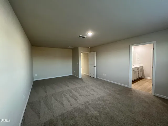 a view of an empty room and a bathroom