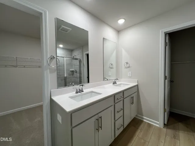 a bathroom with a sink double vanity and a mirror