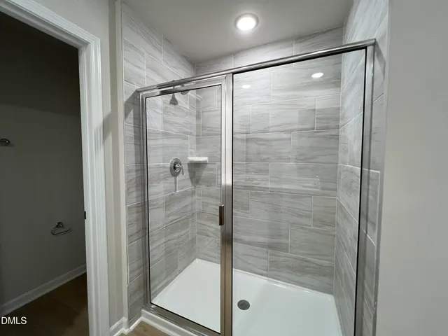 a bathroom with a glass shower door