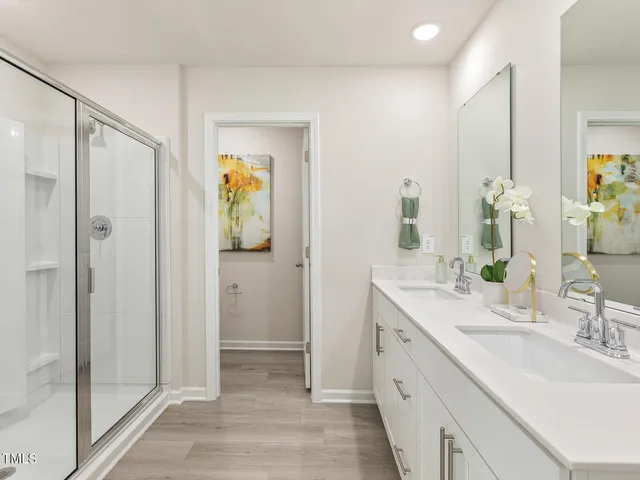 a spacious bathroom with a double vanity sink and a mirror