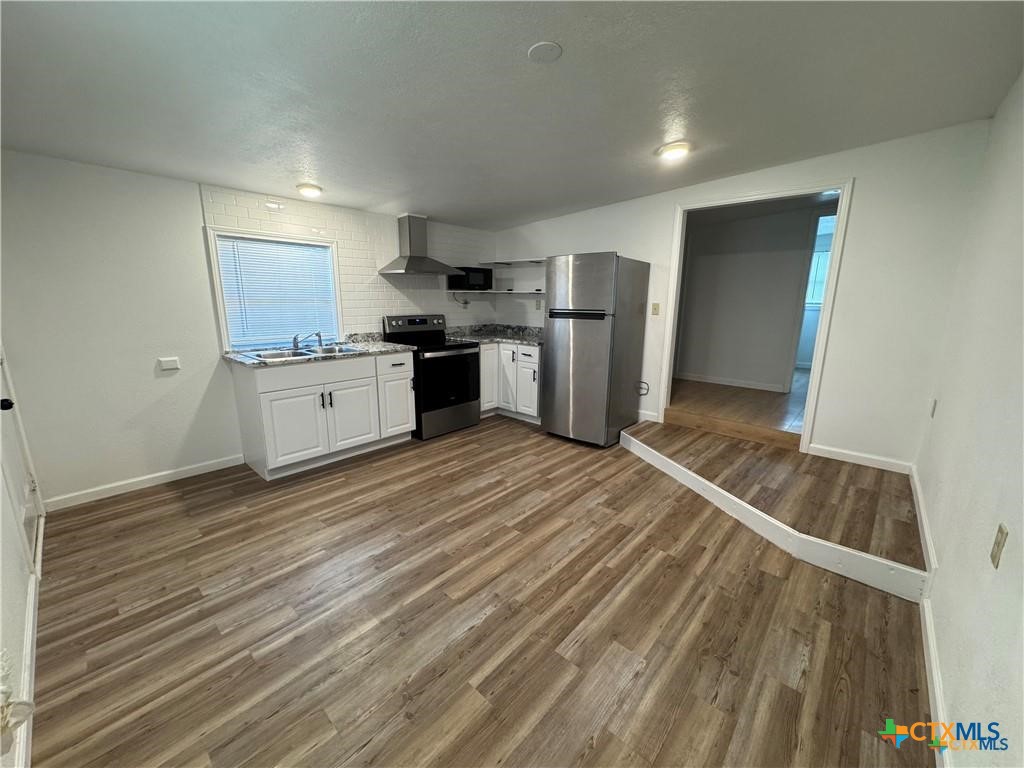 1209 Raymond Street Seguin, TX 78155 - Photo 1 of 11 a kitchen with stainless steel appliances granite countertop a refrigerator sink and cabinets
