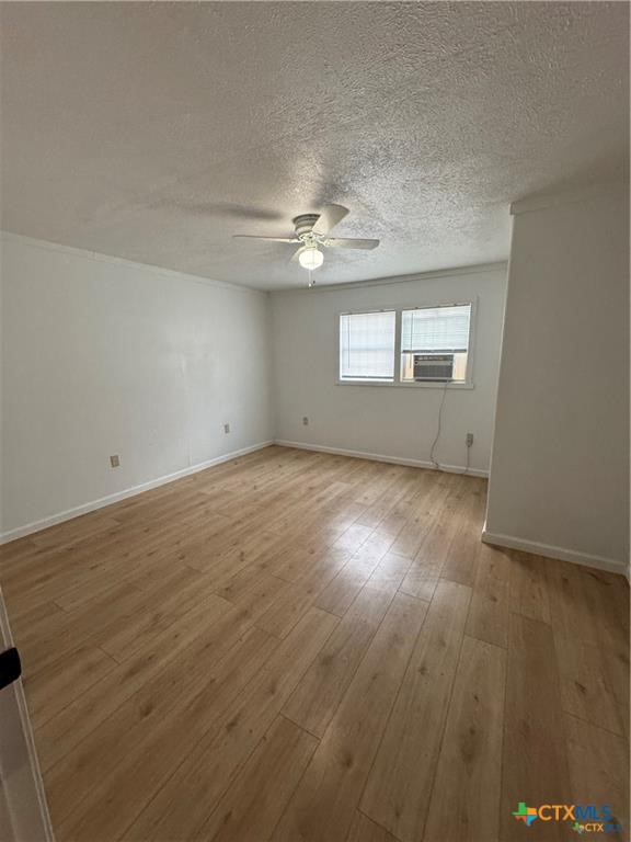 1209 Raymond Street Seguin, TX 78155 - Photo 6 of 11 an empty room with wooden floor and windows