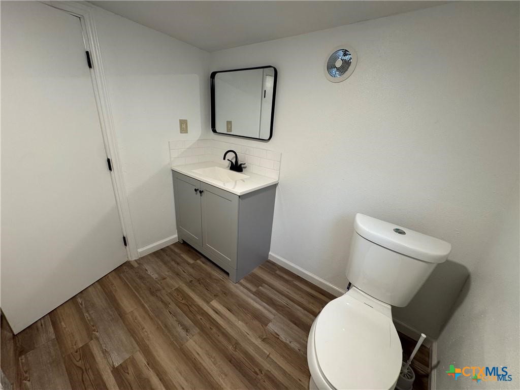 1209 Raymond Street Seguin, TX 78155 - Photo 8 of 11 a bathroom with a toilet sink and mirror