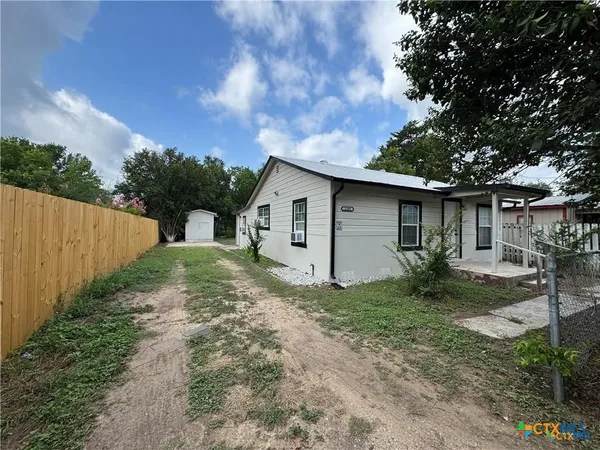 a view of a house with a yard and garage