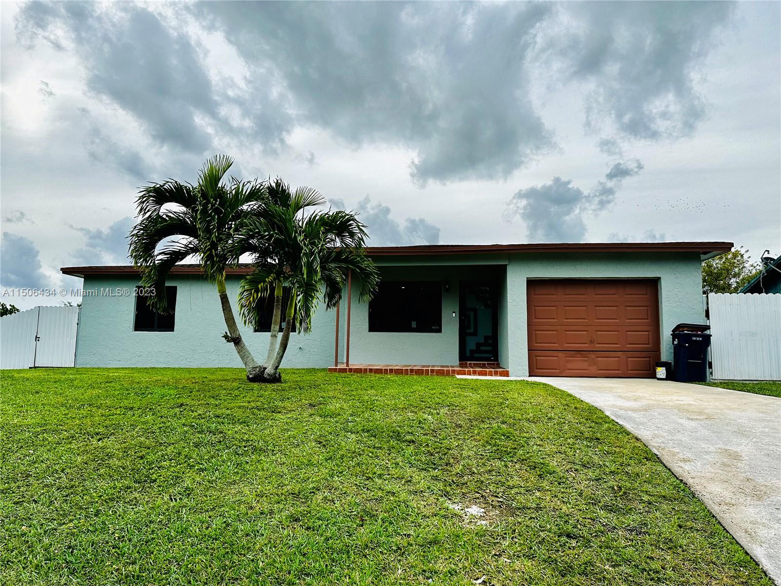 26232 Southwest 124th Place Homestead, FL 33032 - Photo 1 of 33 a view of a yard in front of a house