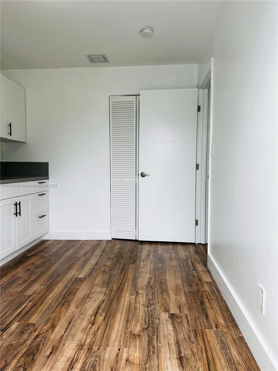 26232 Southwest 124th Place Homestead, FL 33032 - Photo 16 of 33 a view of a room with wooden floor and cabinets