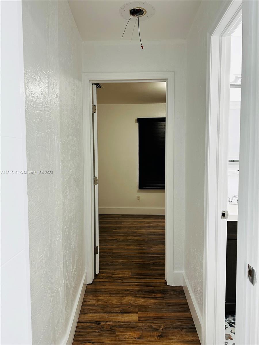 26232 Southwest 124th Place Homestead, FL 33032 - Photo 17 of 33 a view of a hallway with wooden floor and staircase