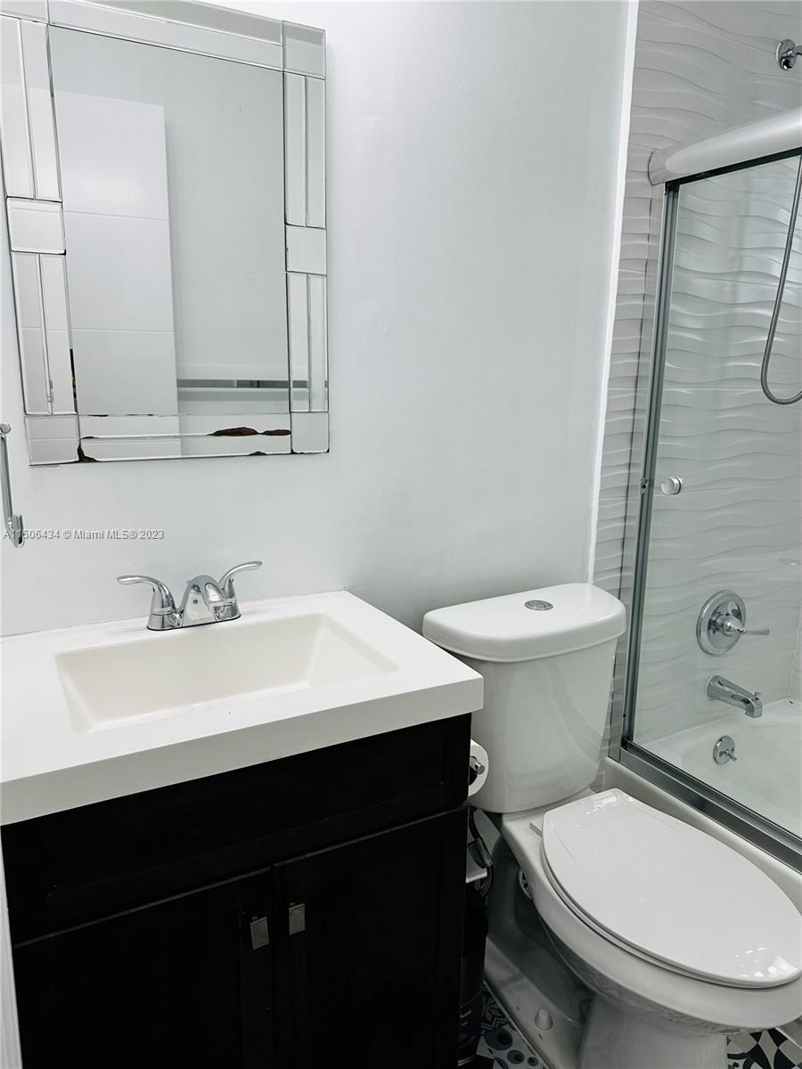 26232 Southwest 124th Place Homestead, FL 33032 - Photo 20 of 33 a bathroom with a sink a toilet a mirror and shower