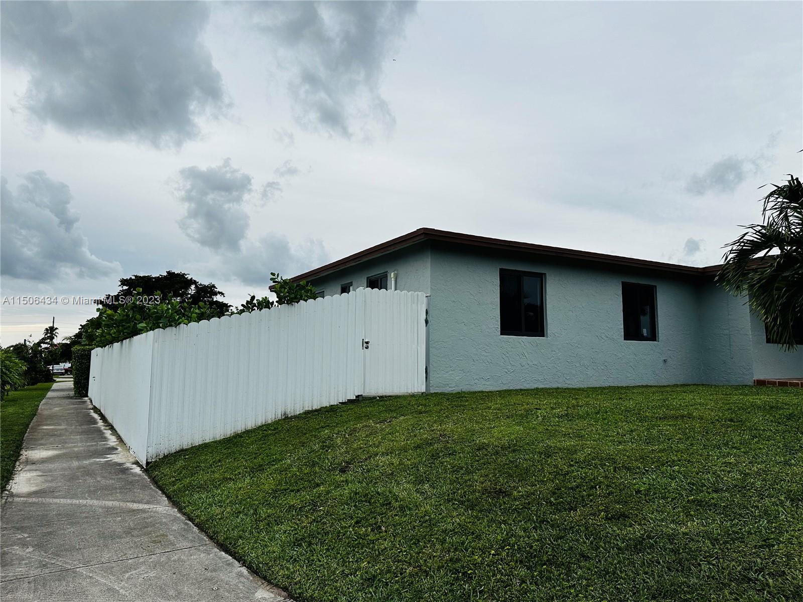 26232 Southwest 124th Place Homestead, FL 33032 - Photo 2 of 33 a backyard of a house with lots of green space